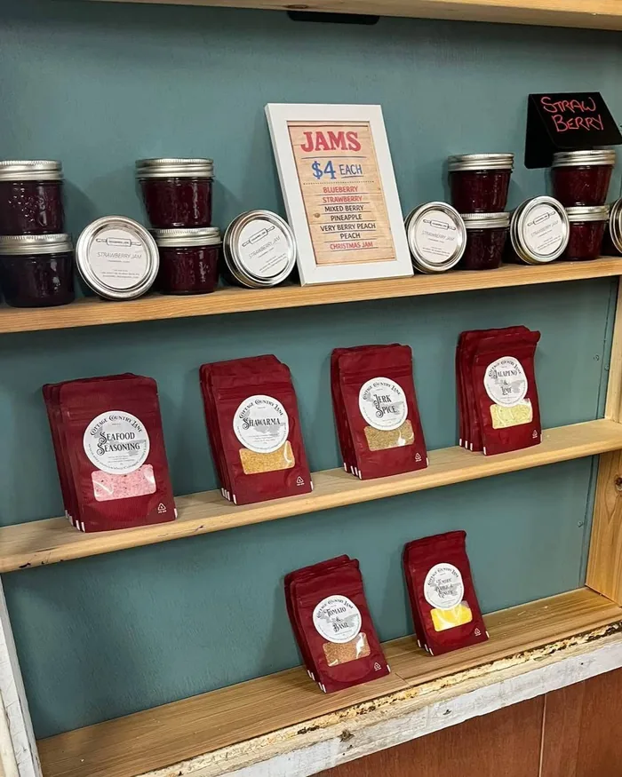 Rows of labelled preserve jars on wooden shelving