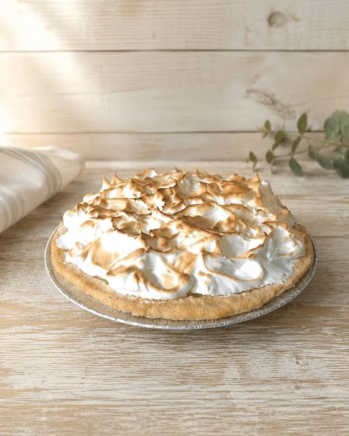 A lemon meringue pie with torched peaks