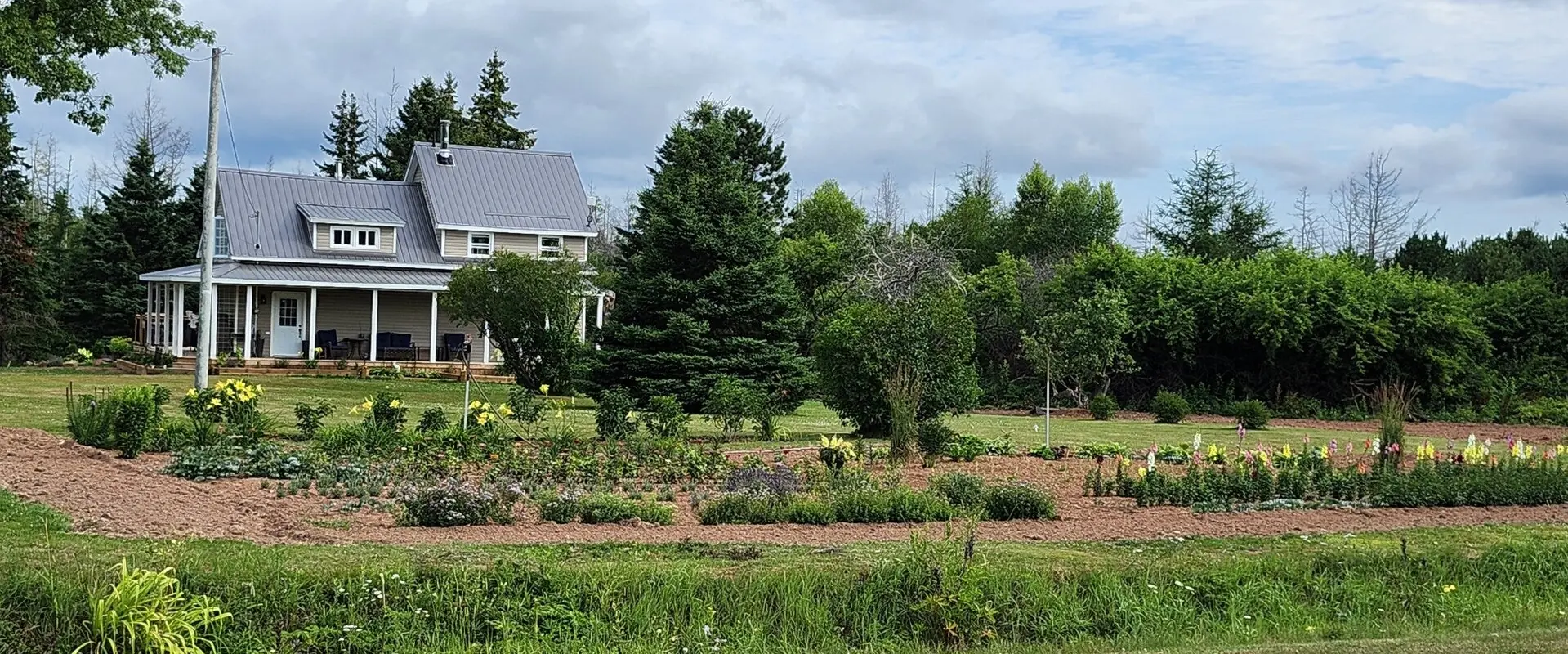 The Dough Rollers farmhouse at 480 Abney Road, gardens across the front