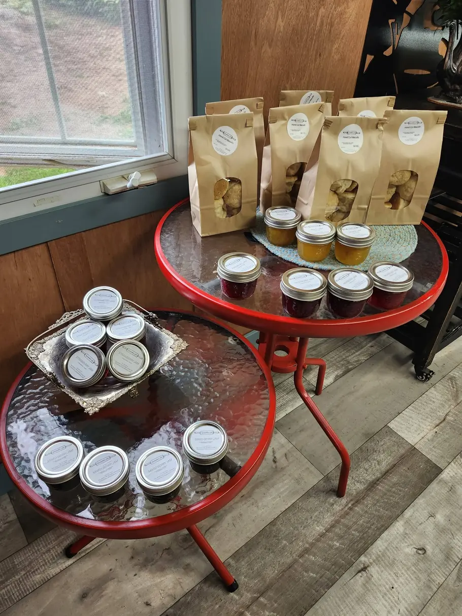 Jars and packaged treats staged on a red side table in the store
